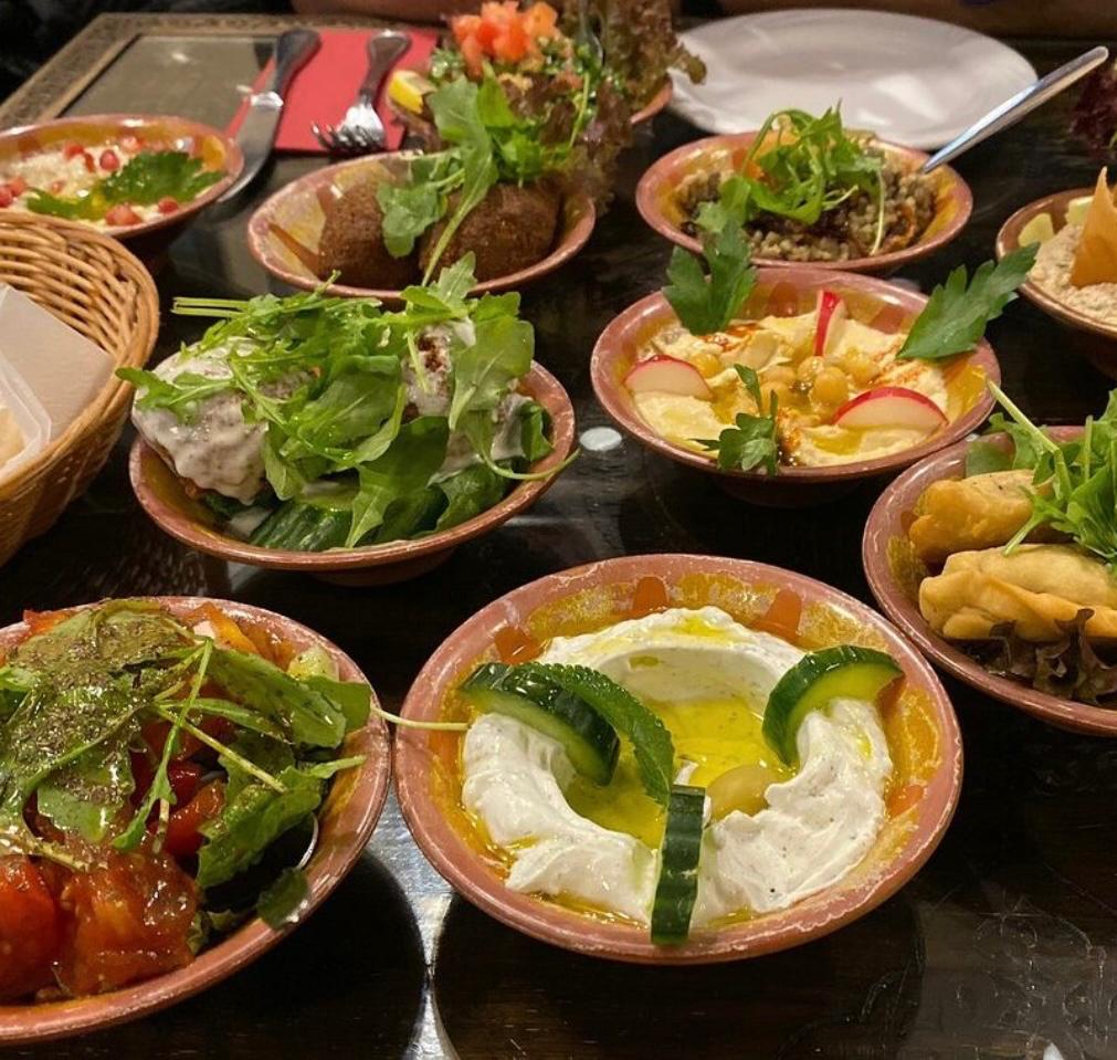 Lebanese mezze spread featuring multiple small dishes with traditional appetizers